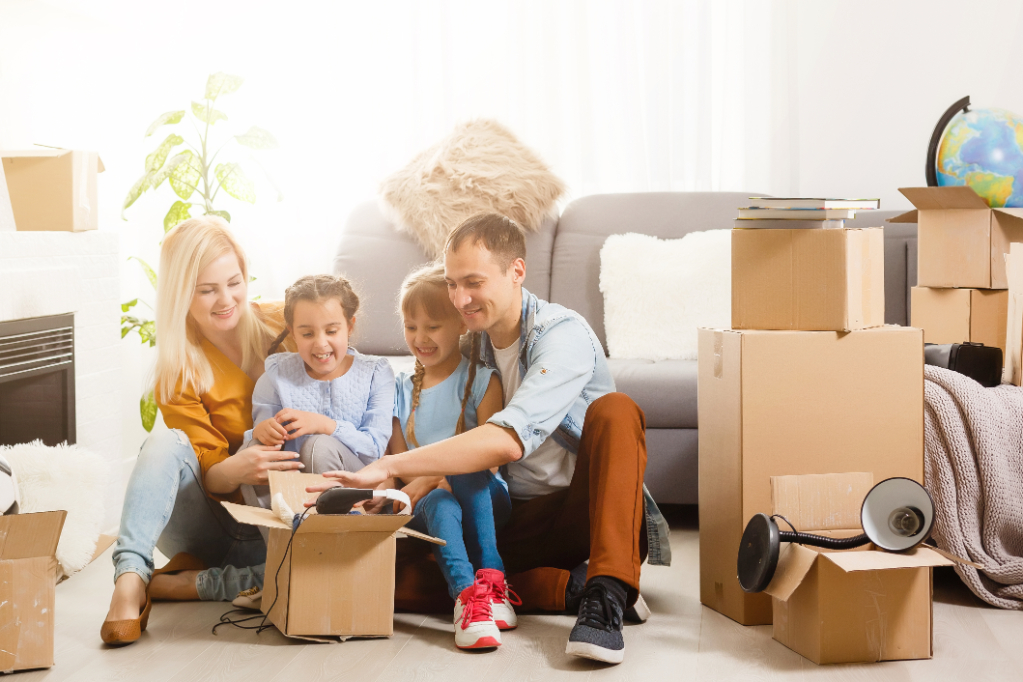 Happy senior couple packing cardboard boxes during relocation